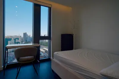 a bedroom with a bed and a desk and a window at 2b2b skyline flat&amazing view! in Moffat