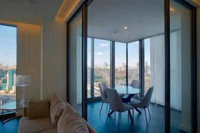 a living room with a couch and a table and chairs at 2b2b skyline flat&amazing view! in Moffat