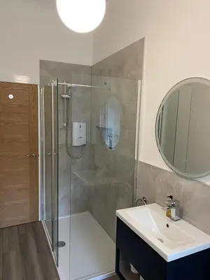 a bathroom with a shower and a sink at Spacious 2 bed sleeps 5 above traditional music pub in Paisley
