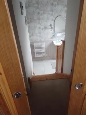 a small bathroom with a sink and a mirror at Ardross Cottage in Aberfoyle