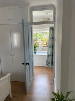 an open door in a room with a window at Glencairn Cottage in Moffat