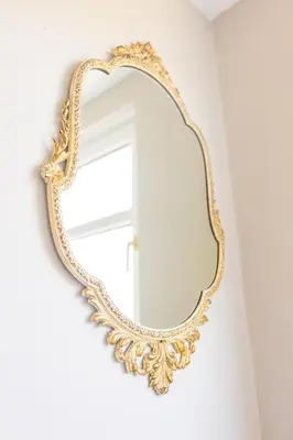 a gold mirror hanging on a wall at Birchgate Bothy - Spacious 4 Bedroom Home in Dunoon in Dunoon