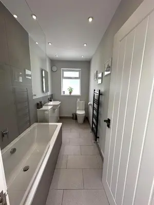 a bathroom with a tub and a toilet and a sink at Kaimes Kip Stylish Edinburgh Five Bedroom Home in Edinburgh