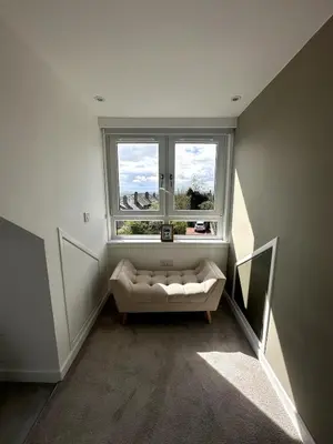 a living room with a couch and a window at Kaimes Kip Stylish Edinburgh Five Bedroom Home in Edinburgh