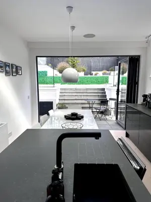 a kitchen with a black counter top in a room at Kaimes Kip Stylish Edinburgh Five Bedroom Home in Edinburgh