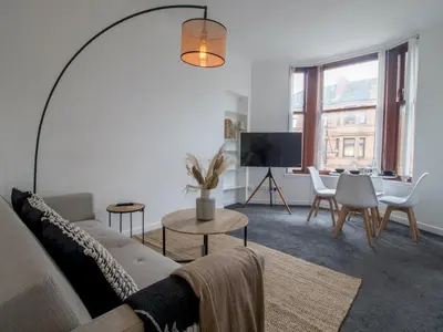 a living room with a couch and a tv at Pass the Keys Stay in Glasgow South in Glasgow