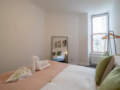 a bedroom with a bed with towel animals on it at Pass the Keys Stay in Glasgow South in Glasgow