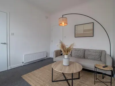 a living room with a couch and a table at Pass the Keys Stay in Glasgow South in Glasgow