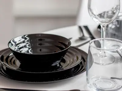 a black bowl on a plate next to a glass at Pass the Keys Stay in Glasgow South in Glasgow