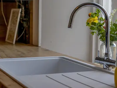 a kitchen sink with a faucet and a plant at Pass the Keys Victoria Road Queens Park View in Glasgow