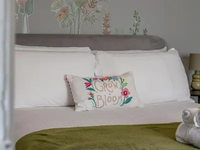 a white bed with a pillow with a grow box at Pass the Keys West End Wonder in Glasgow