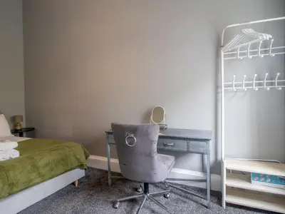 a bedroom with a desk and a bed and a chair at Pass the Keys West End Wonder in Glasgow