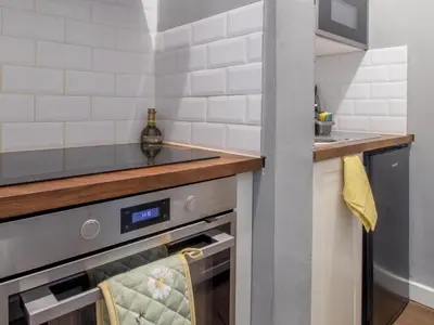 a small kitchen with a sink and a stove at Pass the Keys West End Wonder in Glasgow