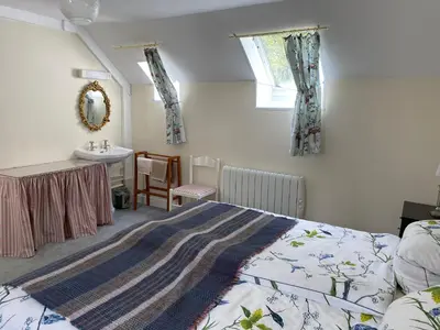 a bedroom with a bed and a sink at Birch Tree Cottage in Killichonan