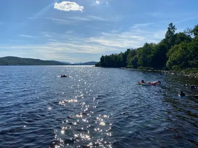 a couple of people in a boat on a lake at Birch Tree Cottage in Killichonan