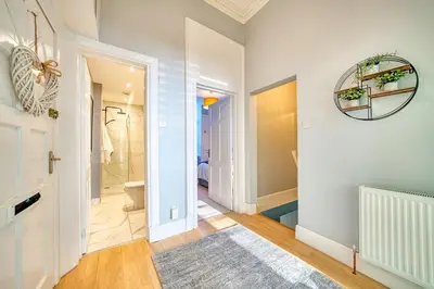a bathroom with a toilet and a walk in shower at 3-Bed Flat Free Parking 10 Mins to City Centre in Glasgow