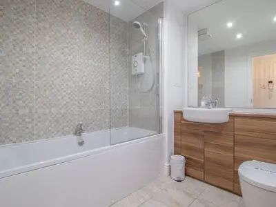 a bathroom with a tub and a sink at Pass the Keys Next to Braehead - Free Parking in Renfrew