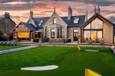 a house with a golf course in front of it at No36 South Beach - Donnini Apartments in Troon