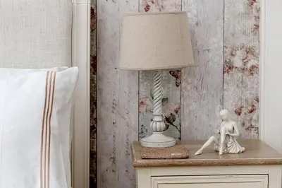 a lamp on a night stand next to a bed at Persie Croft Bed & Breakfast in Auchterarder