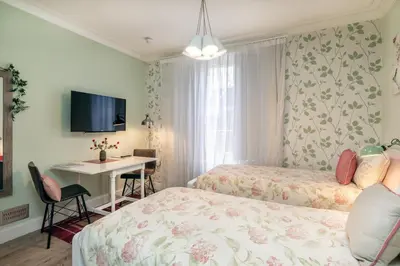 a bedroom with two beds and a table and a desk at Haymarket Apartments in Edinburgh