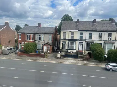 a group of houses on the side of a street at New Stylish Large 1-Bed Apartment - Close to Old Trafford & More in Moffat