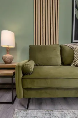 a green couch sitting next to a table with a lamp at Ochill View Apartment by Stirling Train Station in Stirling