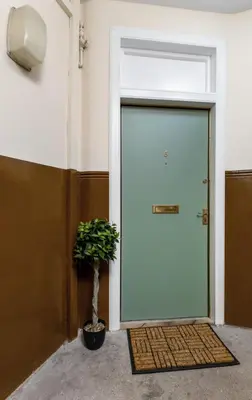 a door with a potted plant in front of it at Ochill View Apartment by Stirling Train Station in Stirling