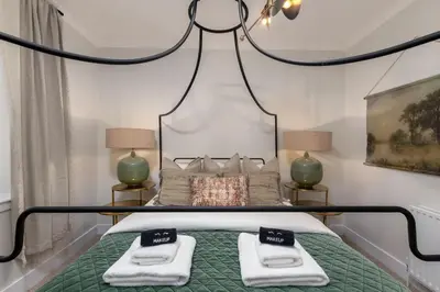 a bedroom with a bed with two towels on it at Woodland Hideaway Near Stirling in Cambusbarron