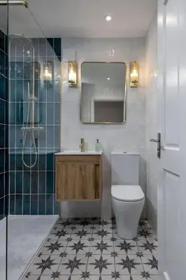 a bathroom with a toilet and a sink and a mirror at Woodland Hideaway Near Stirling in Cambusbarron