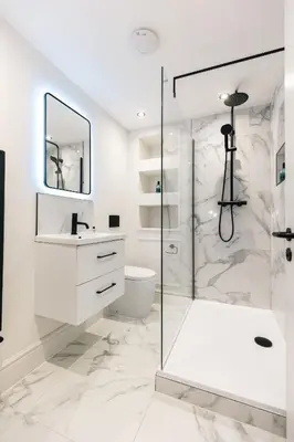 a white bathroom with a shower and a toilet at Luxury Georgian Aparthotel by Hauss Ayr - 5mins to Beach, Town Centre! in Ayr