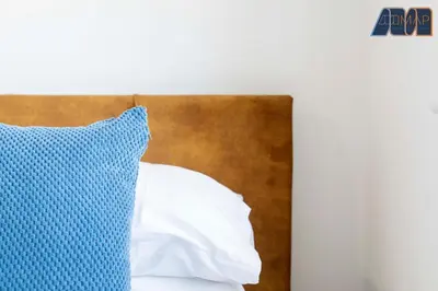 a blue pillow sitting on top of a bed at 3BR Home in Kilmarnock Sleeps 6 in Kilmarnock