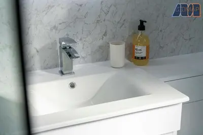 a white sink with a bottle of soap on it at 3BR Home in Kilmarnock Sleeps 6 in Kilmarnock