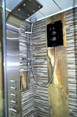 a shower with a shower head in a bathroom at Double room in riverside apartment - B in Glasgow