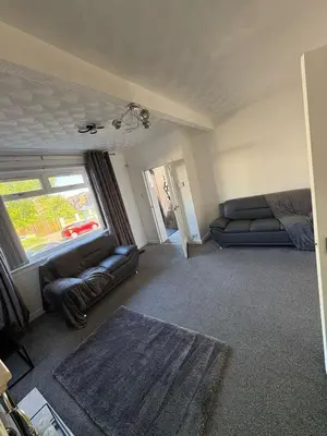 a living room with a couch and a window at Chic & Cozy 2BR Semi-Detached in Kilmarnock