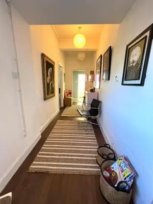 a hallway with a rug on the floor and a stairway at Coatbridge central apartment 20 min from Glasgow in Coatbridge