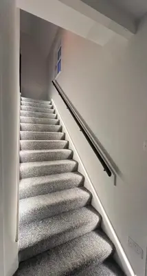 a staircase in a building with grey carpet at CONTRACTOR STAYS WELCOME newly refurbished 2 bedroom apartment sleeps 5 with free SECURE parking and WiFi Fully Fitted Kitchen with Washer Dryer Weekly bedding change and hoover Long Term Stay Rate available 3 miles from City Centre in Cowlairs