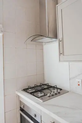 a kitchen with a stove top oven in a kitchen at Stylish 3BR Home near Hampden No 264 with Free Parking in Glasgow