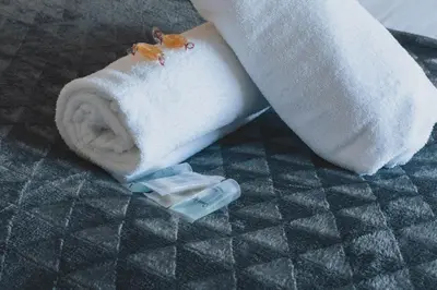 a roll of toilet paper sitting next to a towel at Stylish 3BR Stay by Hampden No 161 with Free Parking in Glasgow