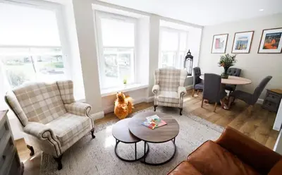 a living room with a couch and chairs and a table at Stylish 3-Bed Apartment in the Heritage Quarter in Dunfermline