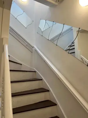 a staircase in a building with a mirror on the wall at Truly Central, Princes St, close to Castle in Edinburgh