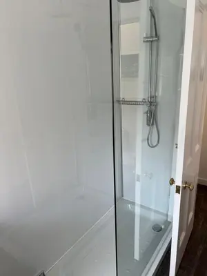 a shower stall with a glass shower door at Truly Central, Princes St, close to Castle in Edinburgh