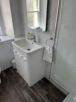 a white bathroom with a sink and a shower at Truly Central, Princes St, close to Castle in Edinburgh
