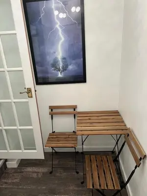 a bench next to a wall with a picture of a tree at Truly Central, Princes St, close to Castle in Edinburgh