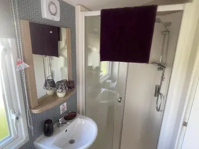a bathroom with a shower and a sink at One Muirfield, Caravan at Turnberry in Turnberry