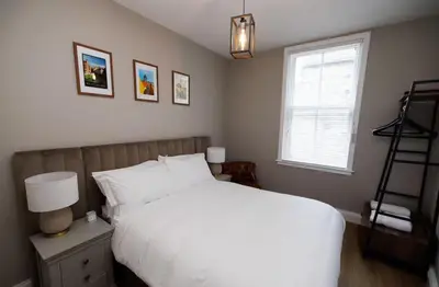 a bedroom with a white bed and a window at Stylish 1-Bed Apartment in the Heritage Quarter in Dunfermline