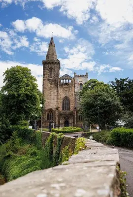 an old stone building with a tower on a street at Stylish 1-Bed Apartment in the Heritage Quarter in Dunfermline