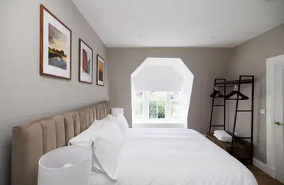 a bedroom with a white bed and a window at Cosy Apartment in the Heritage Quarter - Sleeps 2 in Dunfermline