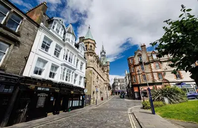 a city street with buildings and a clock tower at Stylish 2-Bed Apartment in the Heritage Quarter in Dunfermline