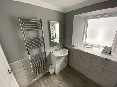 a bathroom with a sink and a toilet and a window at The Anchor Inn in Garelochhead
