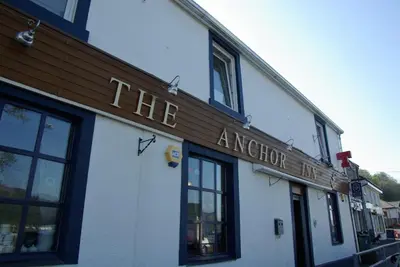 a building with a sign that reads the answer inn at The Anchor Inn in Garelochhead
